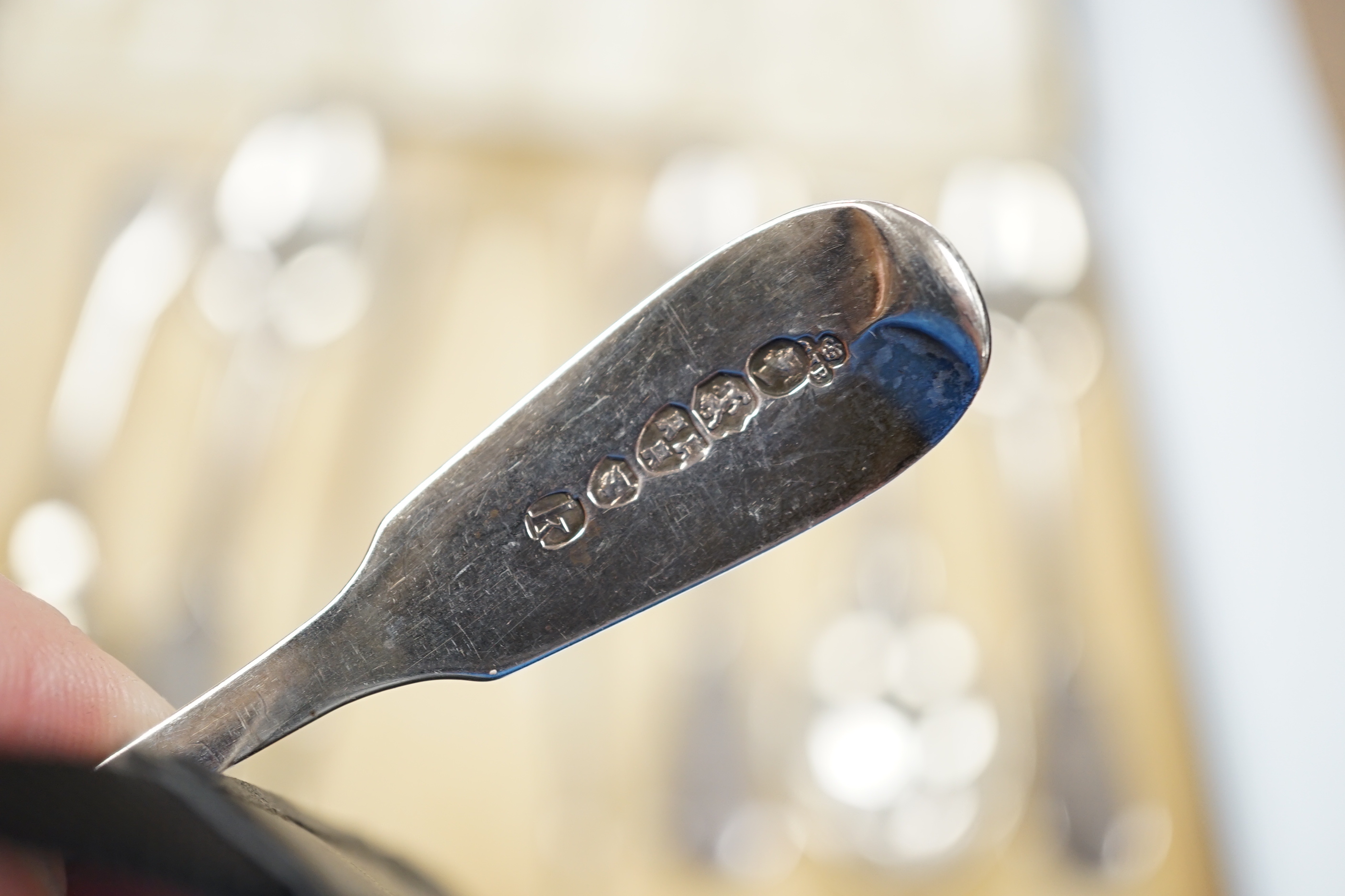 A set of six Victorian provincial silver fiddle pattern teaspoons, Reid & Sons, Newcastle, 1873 and a pair of associated silver sugar tongs, in associated case.